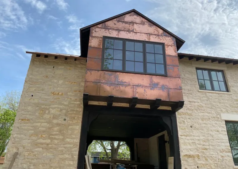 Copper metal panel facade on a stone building for Skylight Installation in Largo